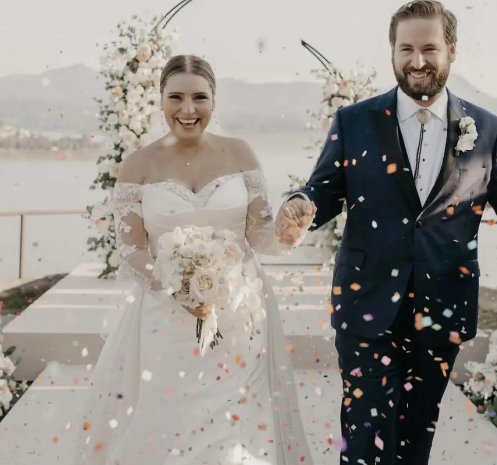 Сouple wearing a white gown and a black suit