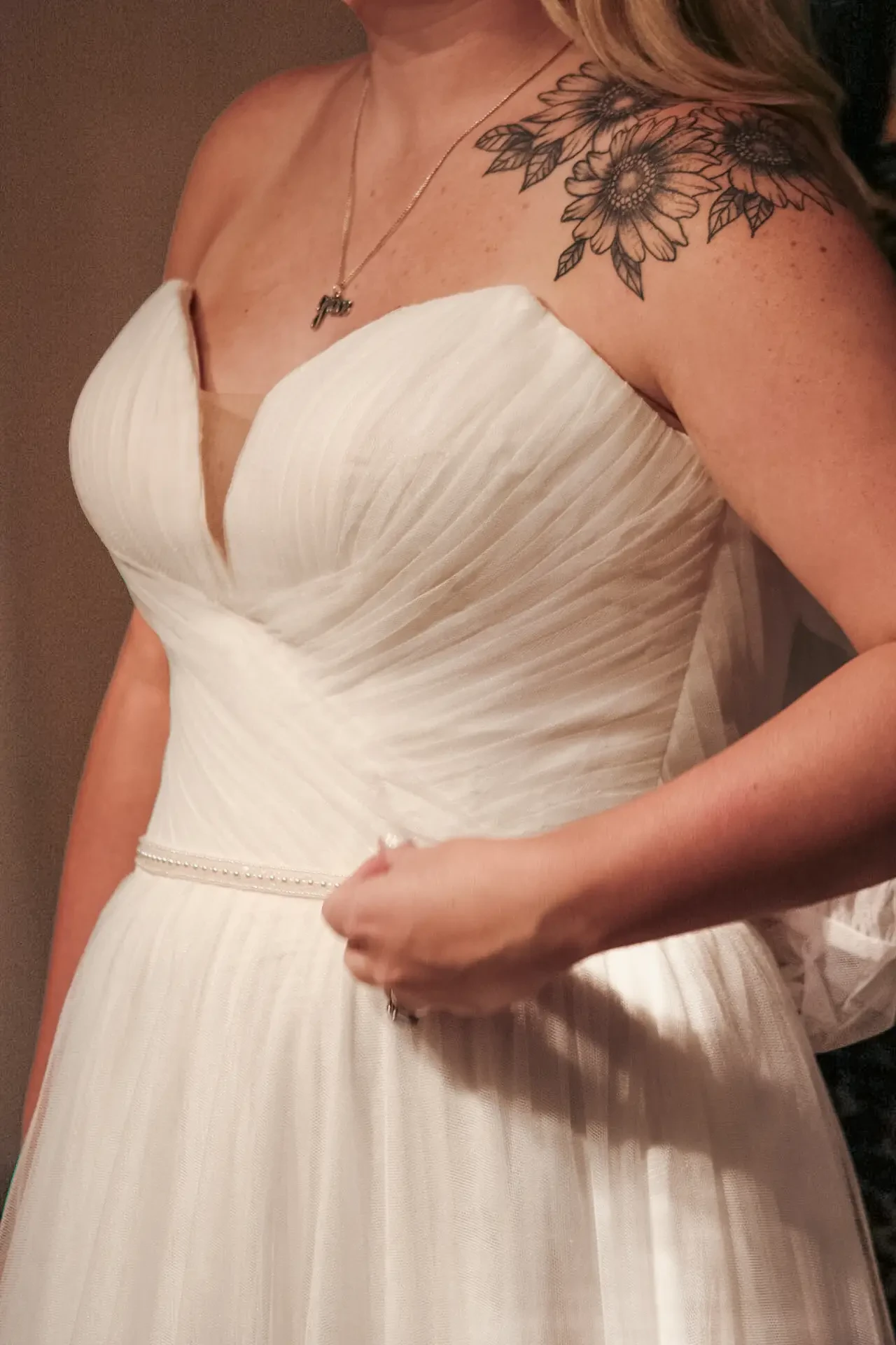 image shows a woman wearing a strapless wedding dress