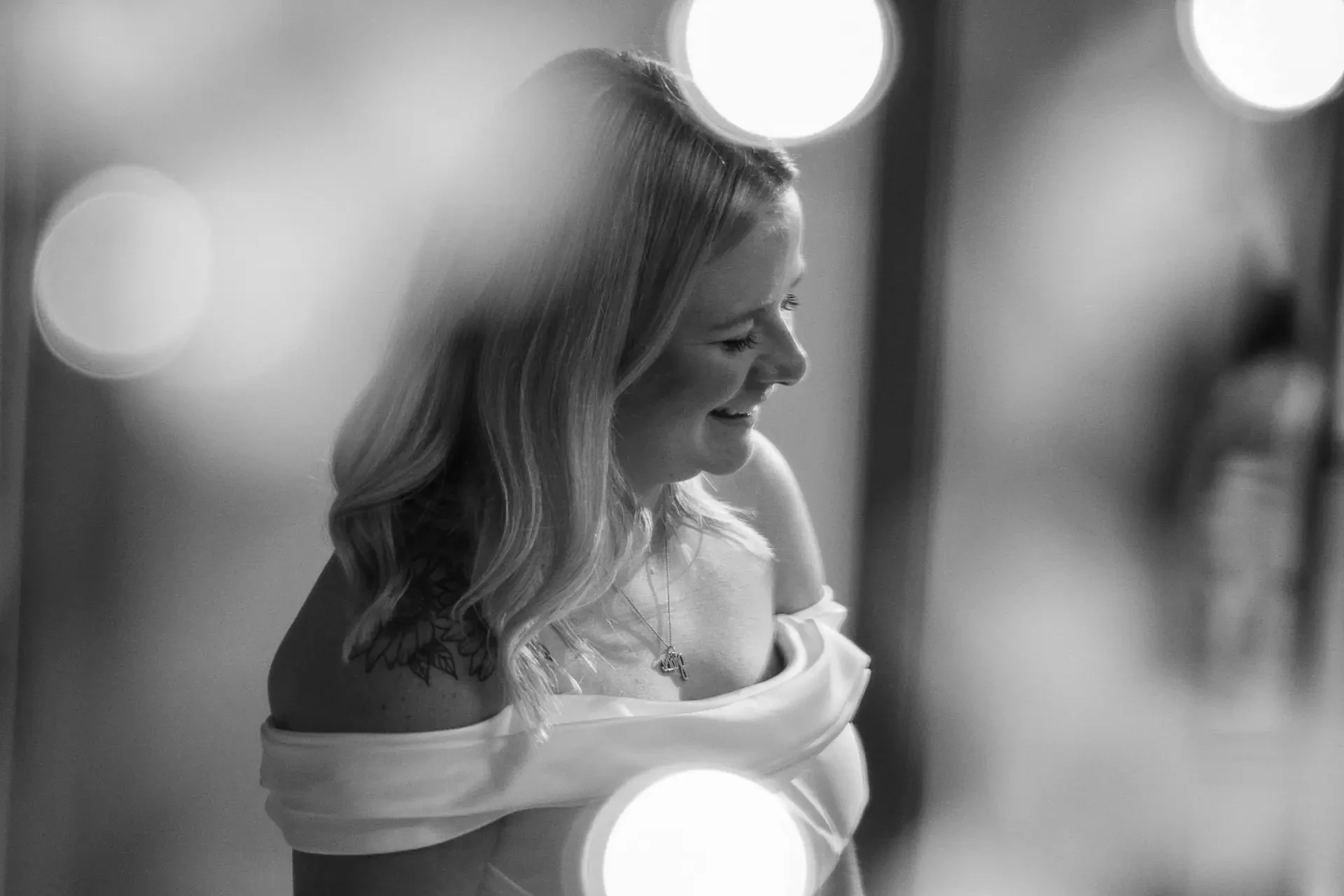 image shows a woman wearing an off the shoulder wedding dress