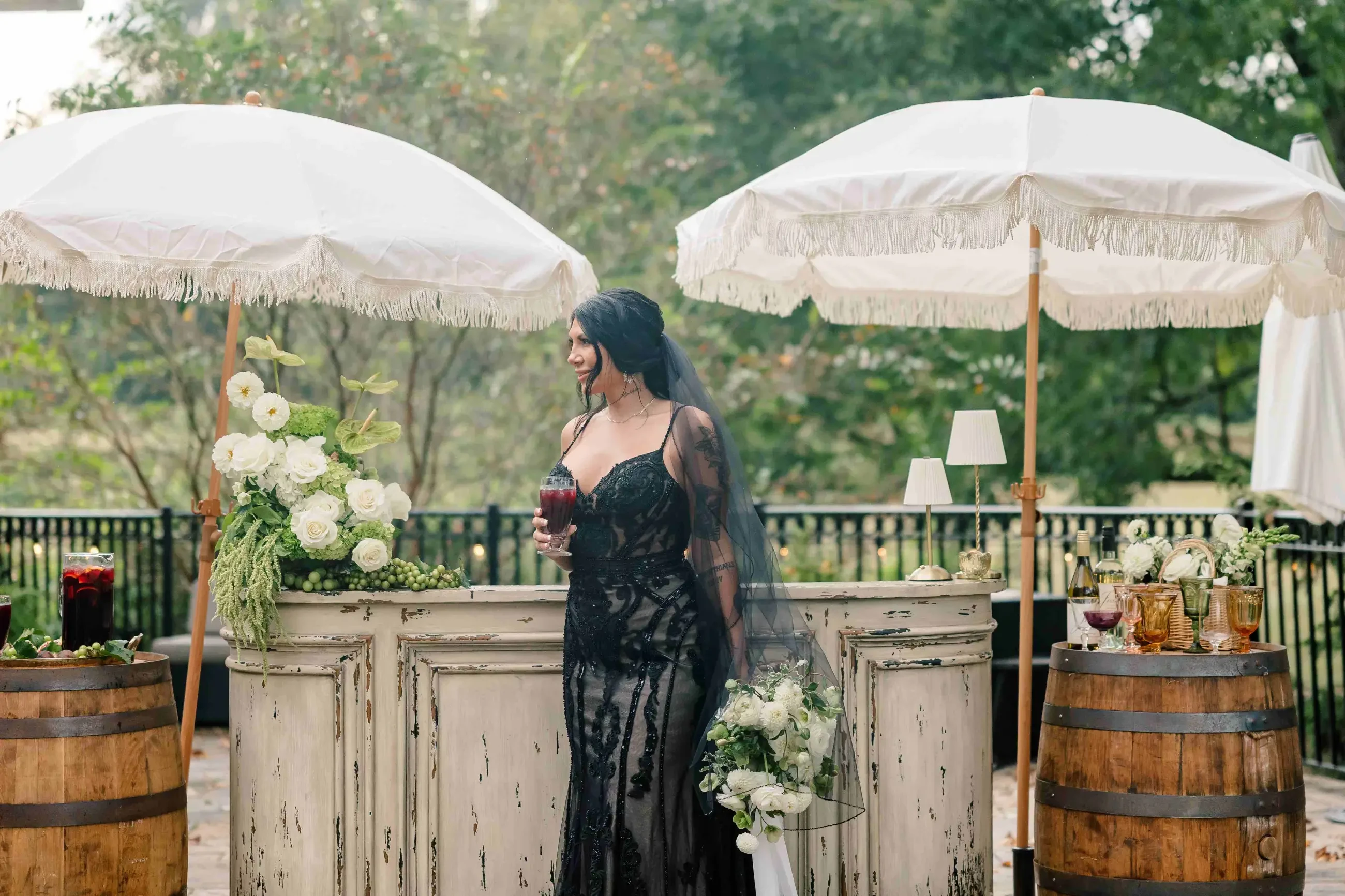 bride is wearing a sleeveless black lace wedding dress
