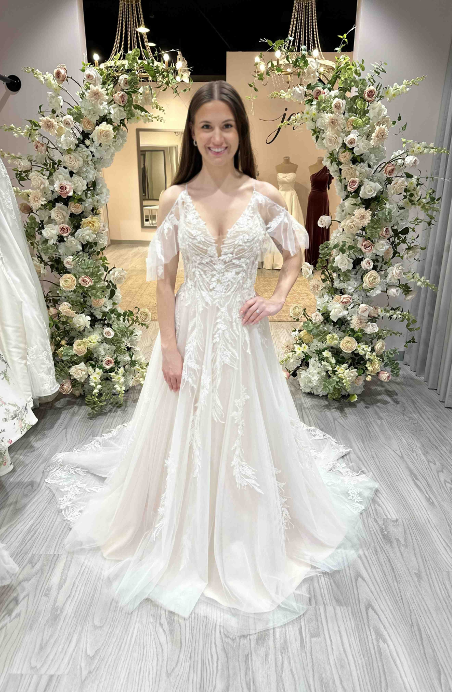 model is wearing an off the shoulder lace wedding dress inspired by taylor swift's debut album