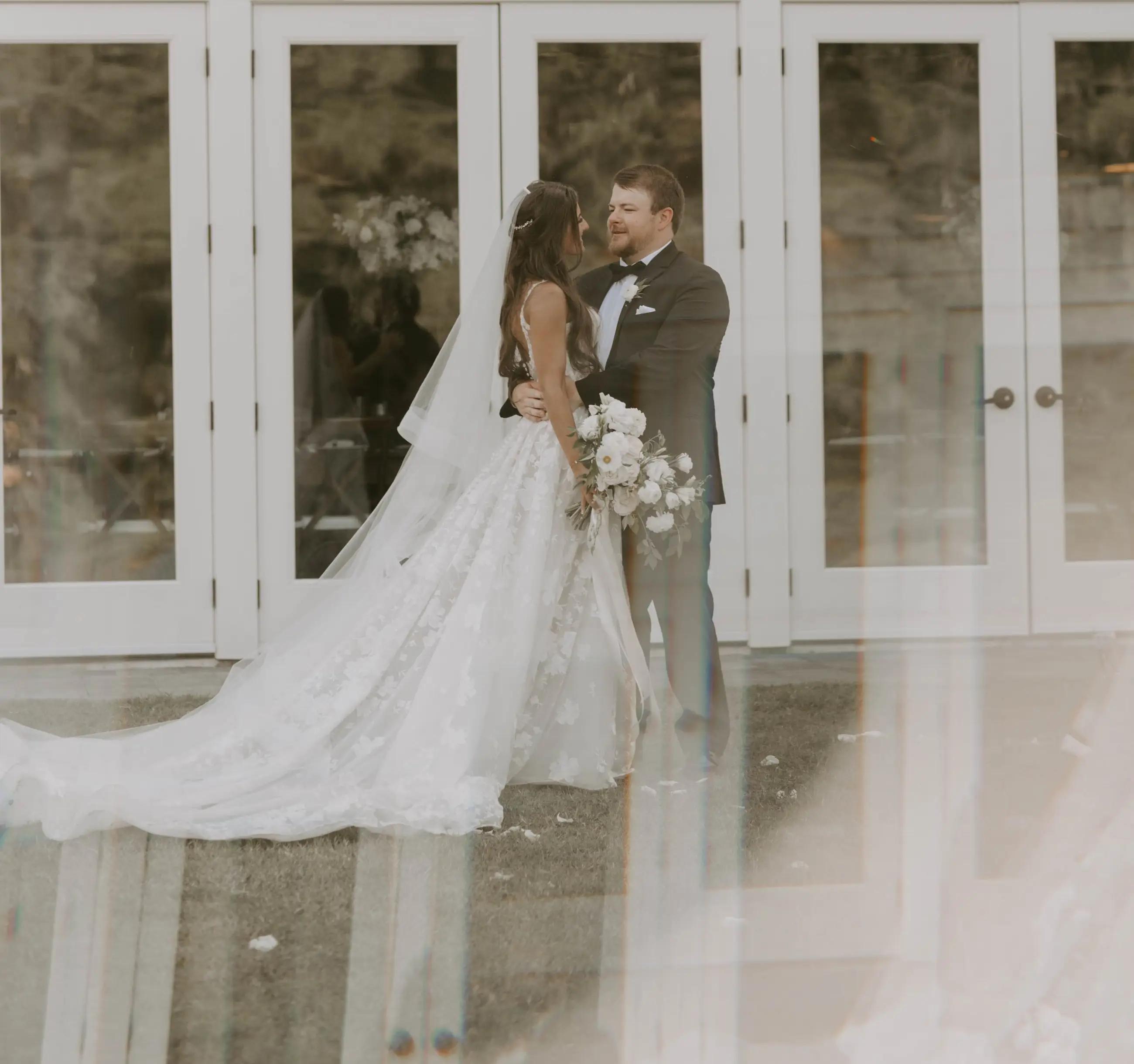 Сouple wearing a white gown and a black suit