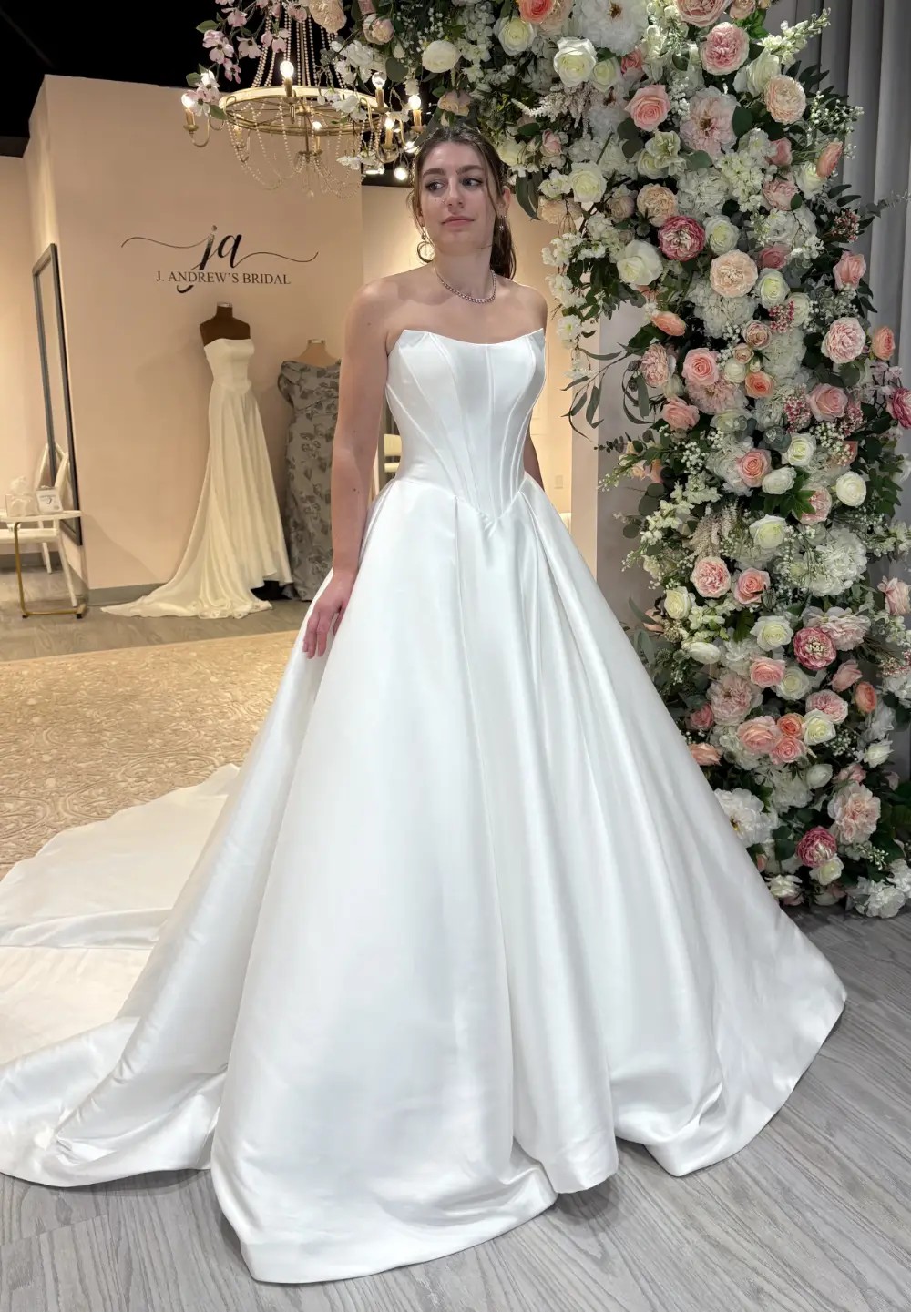 Model wearing a basque waist wedding dress