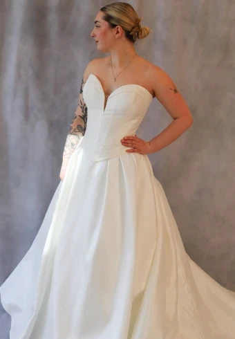 Model wearing a basque waist wedding dress