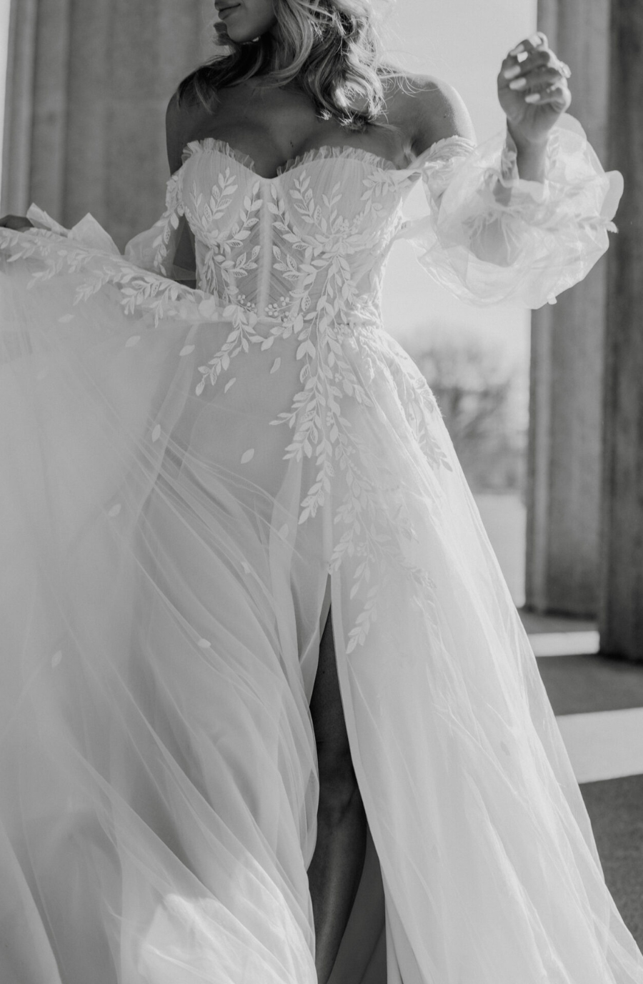 model is wearing an off the shoulder blouson sleeve a-line wedding dress inspired by taylor swift's lover era