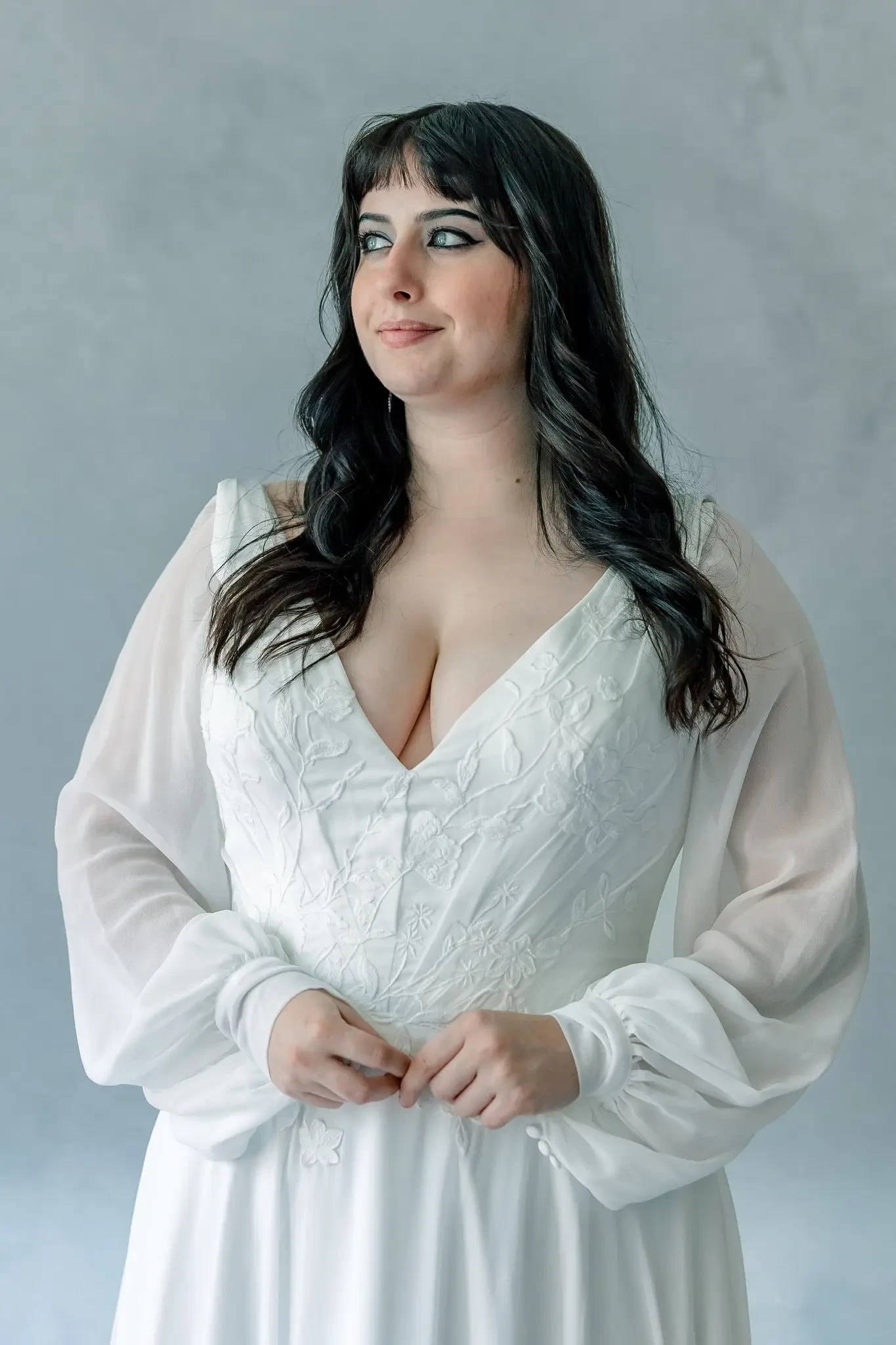 model wearing a plus size wedding gown