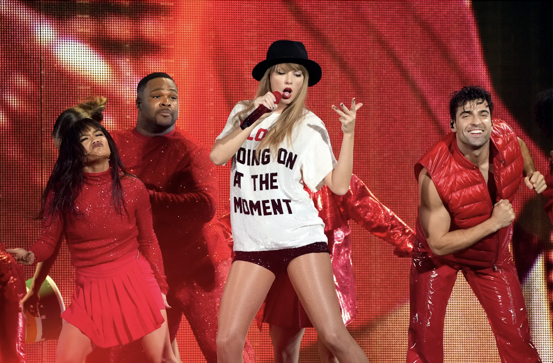image shows taylor swift and her dancers during the red era on the eras tour