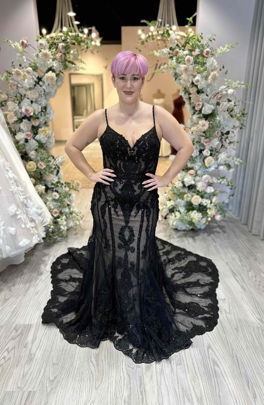 model is wearing a sleeveless black wedding dress inspired by taylor swift's reputation era