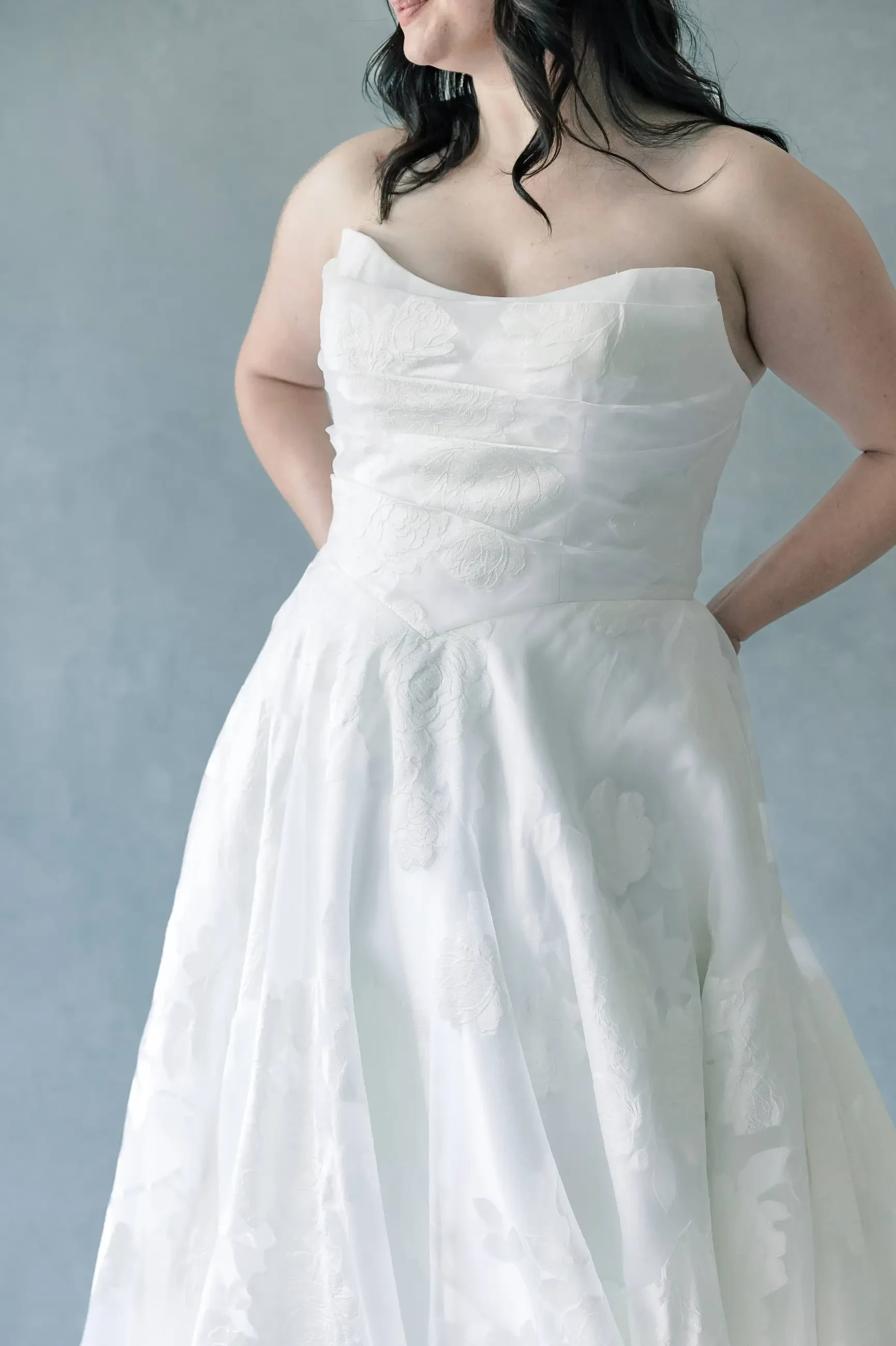 Model wearing a basque waist wedding dress