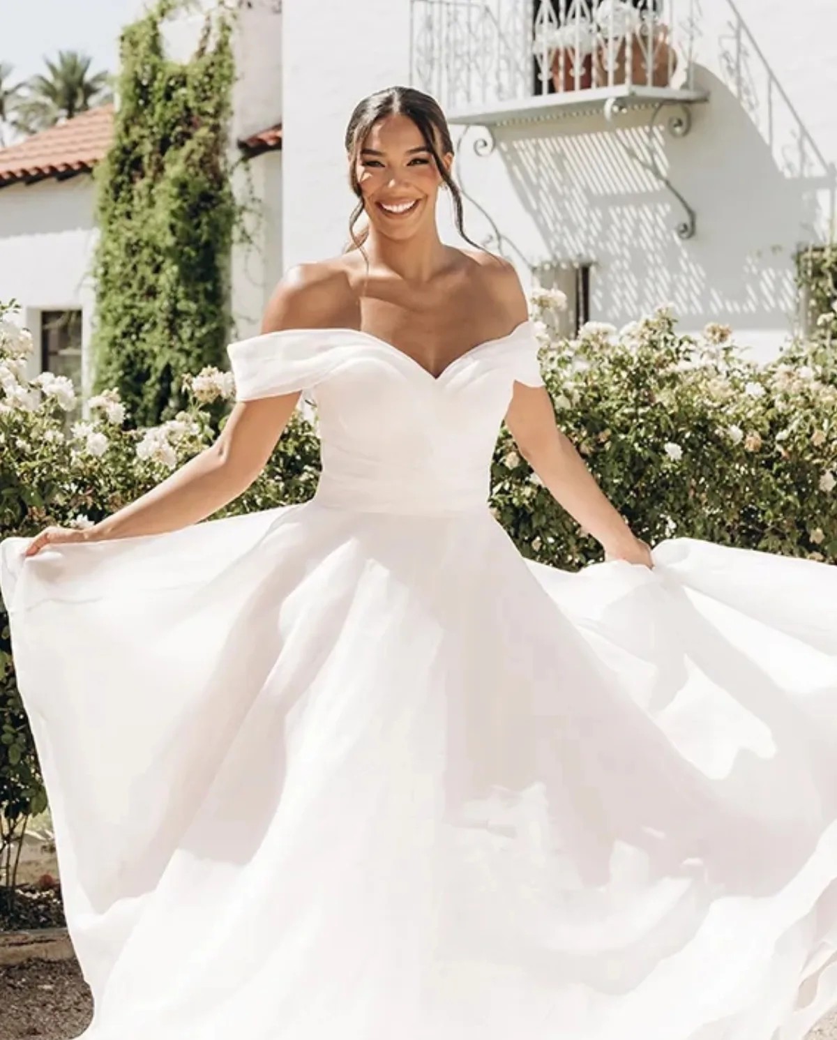 Model wearing a offshoulder dress